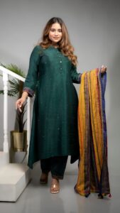 Woman in green kurta with colorful dupatta at a Kolkata event.