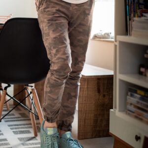 person in brown pants and green and white nike sneakers