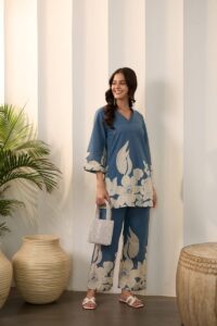 A woman wearing a blue floral print outfit